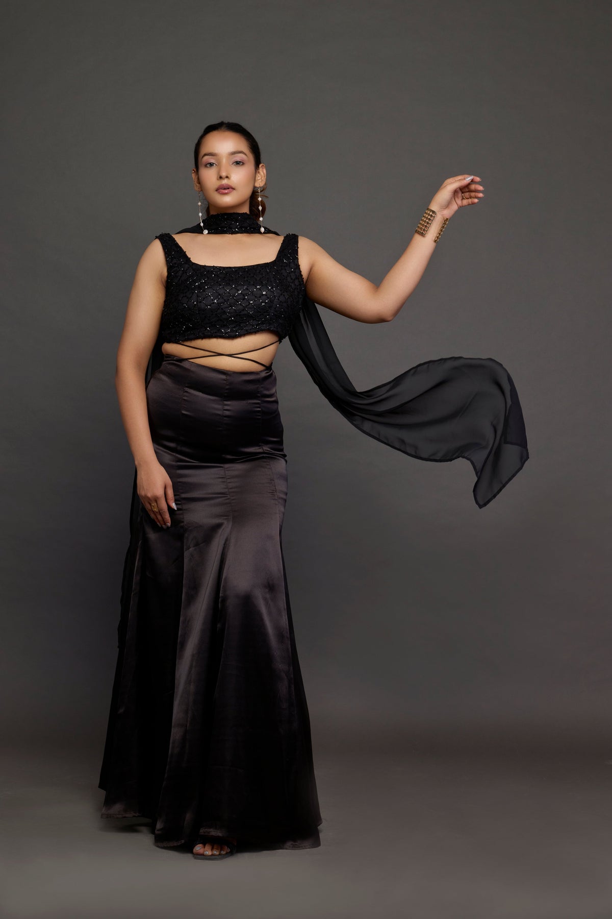 Ratri black sequin embellished top with satin fishtail skirt and chiffon drape