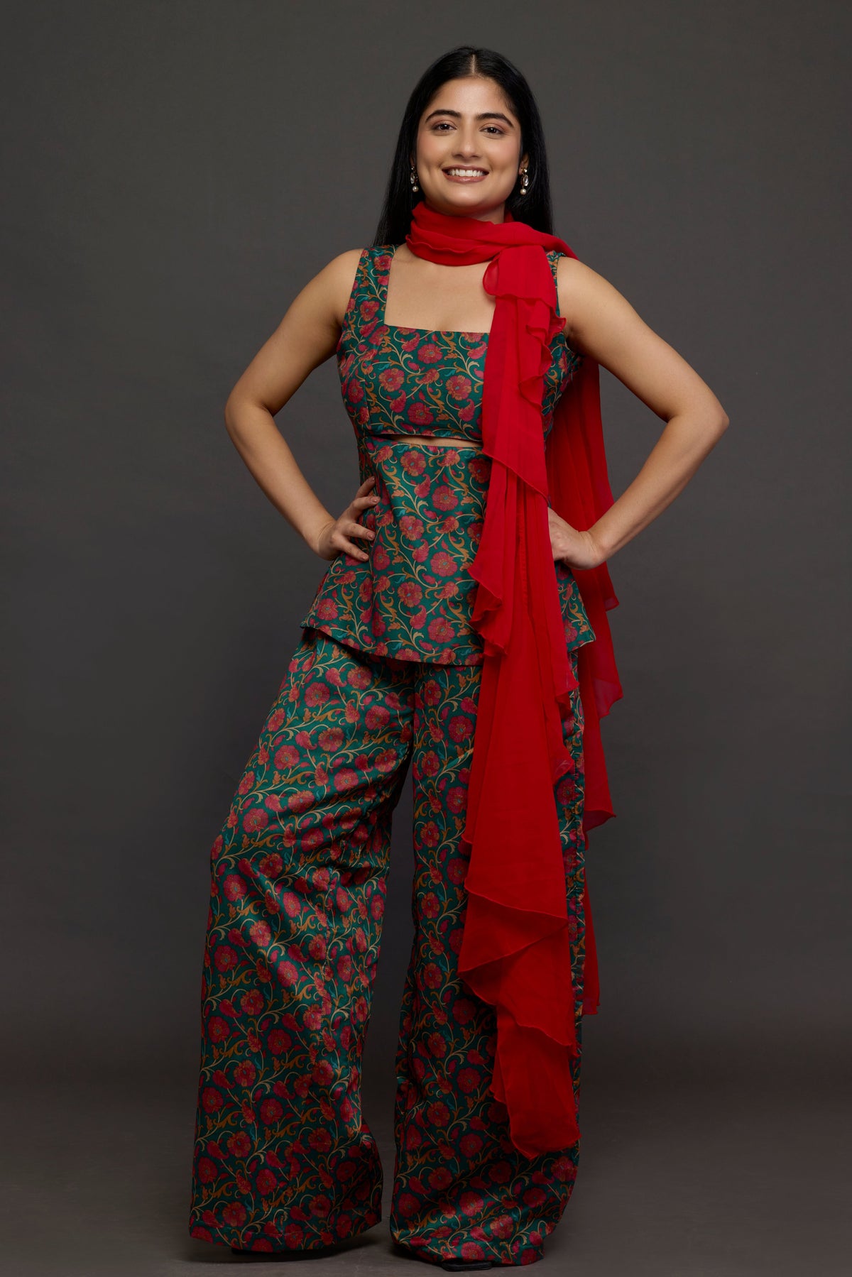 Shyamli emerald floral peplum top with wide-leg pants and red ruffled drape - front